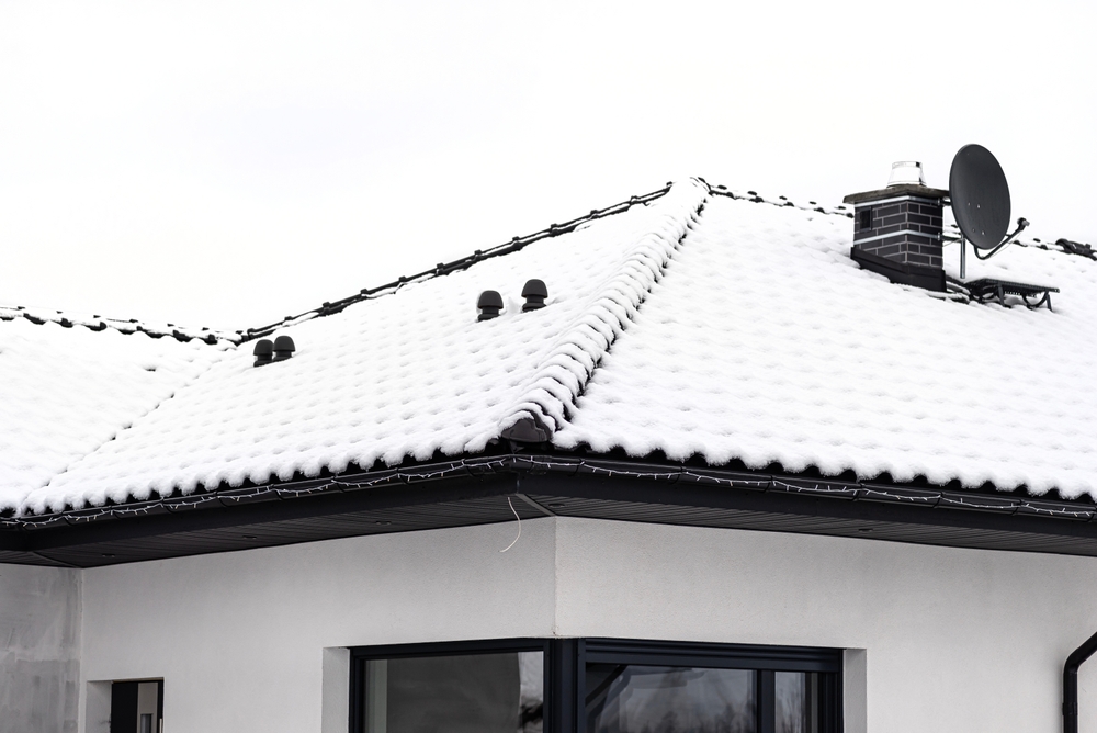 snow on a residential roof with proper ventilation